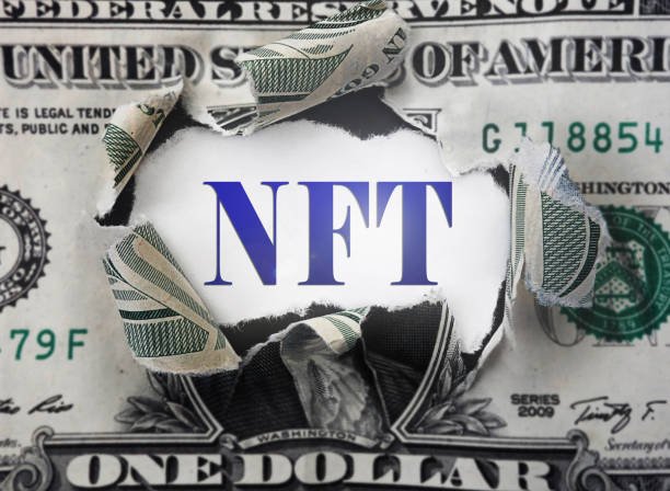 NFT ( Non-Fungible Token --  a blockchain asset) text in a torn dollar bill